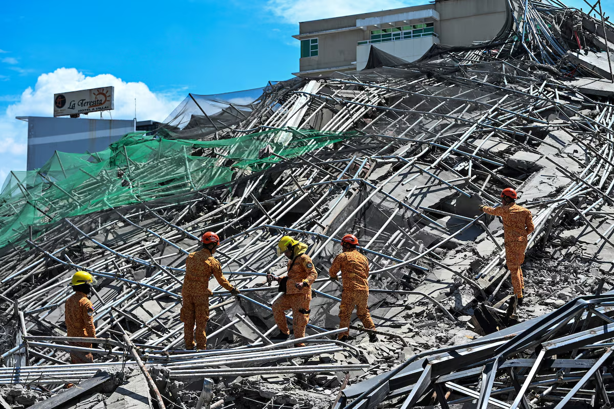 Rescue teams search for more than 20 people trapped after building collapse in Philippines